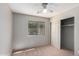 Bedroom with carpet flooring, ceiling fan, and sliding door closet at 30573 N Royal Oak Way, San Tan Valley, AZ 85143