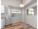 Bright dining area with wood-look floors and view of living room at 30573 N Royal Oak Way, San Tan Valley, AZ 85143