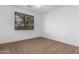 Bright bedroom with window, neutral carpeting, and ceiling fan at 30773 N 129Th Ave, Peoria, AZ 85383