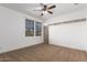 Spacious bedroom with neutral carpeting and ceiling fan at 30773 N 129Th Ave, Peoria, AZ 85383