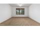 Well-lit bedroom featuring neutral carpeting and ceiling fan at 30773 N 129Th Ave, Peoria, AZ 85383