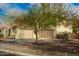 Two-car garage; attractive landscaping surrounds the house at 30773 N 129Th Ave, Peoria, AZ 85383