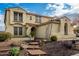 Two-story house with tile roof, stone accents, and a three-car garage at 30773 N 129Th Ave, Peoria, AZ 85383