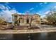 Two-story house with tile roof and landscaped yard, showcasing its curb appeal at 30773 N 129Th Ave, Peoria, AZ 85383