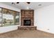 Cozy corner fireplace with stone surround in a bright room at 30773 N 129Th Ave, Peoria, AZ 85383