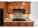 Gas cooktop and granite countertop in this well-lit kitchen at 30773 N 129Th Ave, Peoria, AZ 85383