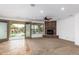 Living room with a stone fireplace, tiled floors, and access to backyard at 30773 N 129Th Ave, Peoria, AZ 85383