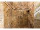 Large walk-in shower with stone tile and built-in shelf at 30773 N 129Th Ave, Peoria, AZ 85383