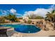 Stunning pool with a rock waterfall feature at 30773 N 129Th Ave, Peoria, AZ 85383