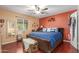 Spacious bedroom with a large bed, ceiling fan, and hardwood floors at 3136 W Sunnyside Ave, Phoenix, AZ 85029