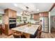 Modern kitchen with granite island, stainless steel appliances, and wooden cabinets at 3136 W Sunnyside Ave, Phoenix, AZ 85029