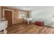 Living room with wood floors, stone accent wall, and piano at 3136 W Sunnyside Ave, Phoenix, AZ 85029