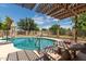 Swimming pool with pergola, table, and chairs at 3136 W Sunnyside Ave, Phoenix, AZ 85029