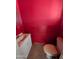 Small bathroom with toilet and sink, red walls at 33767 W Grande Rd, Stanfield, AZ 85172