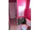 Pink bathroom with toilet, bathtub, and damaged walls at 33767 W Grande Rd, Stanfield, AZ 85172