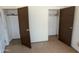 Bedroom with double closets and worn flooring at 33767 W Grande Rd, Stanfield, AZ 85172