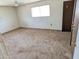 Spacious carpeted bedroom with a window and closet at 33767 W Grande Rd, Stanfield, AZ 85172