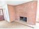 Brick fireplace in a living room with worn carpeting at 33767 W Grande Rd, Stanfield, AZ 85172