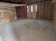 Unfinished garage with wooden walls and open door at 33767 W Grande Rd, Stanfield, AZ 85172