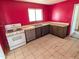 Kitchen with white appliances and pink walls at 33767 W Grande Rd, Stanfield, AZ 85172