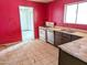 Kitchen with white appliances and pink walls at 33767 W Grande Rd, Stanfield, AZ 85172