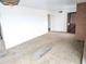 Living room with brick fireplace and worn carpet at 33767 W Grande Rd, Stanfield, AZ 85172