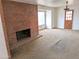 Living room with brick fireplace and sliding glass door to patio at 33767 W Grande Rd, Stanfield, AZ 85172