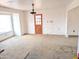 Living room with worn carpet and a door to exterior at 33767 W Grande Rd, Stanfield, AZ 85172