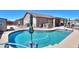 Inviting backyard oasis featuring a sparkling pool, hot tub, and patio area at 3818 N Kalispell Ct, Casa Grande, AZ 85122