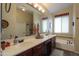 Bathroom with double sinks, a tub, and a large mirror at 3818 N Kalispell Ct, Casa Grande, AZ 85122