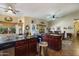 Kitchen features dark wood cabinets, granite counters, and island at 3818 N Kalispell Ct, Casa Grande, AZ 85122