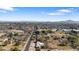 Aerial view of property, showing home, surrounding landscape, and distant mountains at 4035 W Country Gables Dr, Phoenix, AZ 85053