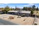 Aerial view of a single-story home with a gravel driveway and desert landscaping at 4035 W Country Gables Dr, Phoenix, AZ 85053