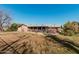 Wider view of backyard, showing home and landscaping at 4035 W Country Gables Dr, Phoenix, AZ 85053