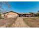 Home's backyard, showing covered patio and workshop at 4035 W Country Gables Dr, Phoenix, AZ 85053