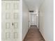 Clean hallway with light walls and wood-look tile flooring at 4035 W Country Gables Dr, Phoenix, AZ 85053