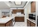 Kitchen with wood cabinets, island, and stainless steel appliances at 4035 W Country Gables Dr, Phoenix, AZ 85053