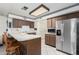 Kitchen with wood cabinets and stainless steel refrigerator at 4035 W Country Gables Dr, Phoenix, AZ 85053