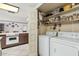 Convenient laundry room with washer, dryer, and storage shelves at 4035 W Country Gables Dr, Phoenix, AZ 85053