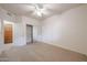 Bedroom with mirrored closet doors and ceiling fan at 4116 E Sunnyside Dr, Phoenix, AZ 85028