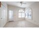 Bright dining area with white tile floors and arched windows at 4116 E Sunnyside Dr, Phoenix, AZ 85028