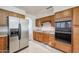 Kitchen with ample wood cabinets and stainless steel appliances at 4116 E Sunnyside Dr, Phoenix, AZ 85028