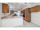 Galley-style kitchen with wood cabinets and stainless steel appliances at 4116 E Sunnyside Dr, Phoenix, AZ 85028