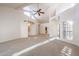 Spacious living room featuring high ceilings, a ceiling fan, and lots of natural light at 4116 E Sunnyside Dr, Phoenix, AZ 85028