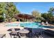 Relaxing community pool area with tables and umbrellas at 4116 E Sunnyside Dr, Phoenix, AZ 85028