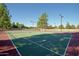 Community tennis courts with green surface and lights at 4116 E Sunnyside Dr, Phoenix, AZ 85028