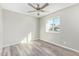 This bedroom features wood-look flooring, a ceiling fan, and a window at 4220 W State Ave, Phoenix, AZ 85051