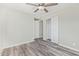 This bedroom features wood-look flooring, a ceiling fan, and a closet with sliding doors at 4220 W State Ave, Phoenix, AZ 85051