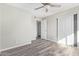 Bedroom featuring a ceiling fan, closet, and wood-style floors at 4220 W State Ave, Phoenix, AZ 85051