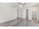 Bedroom featuring wood style floors, ceiling fan, and closet storage space at 4220 W State Ave, Phoenix, AZ 85051